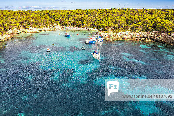 Spain  Balearic Islands  Menorca  Aerial view of boats in Cala Turqueta bay
