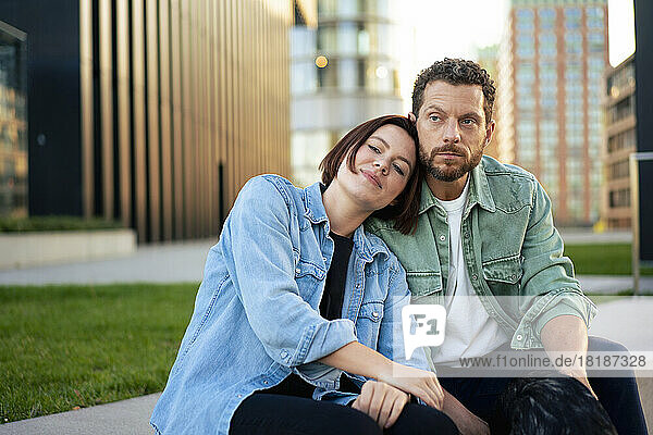 Couple wearing denim shirts sitting on bench