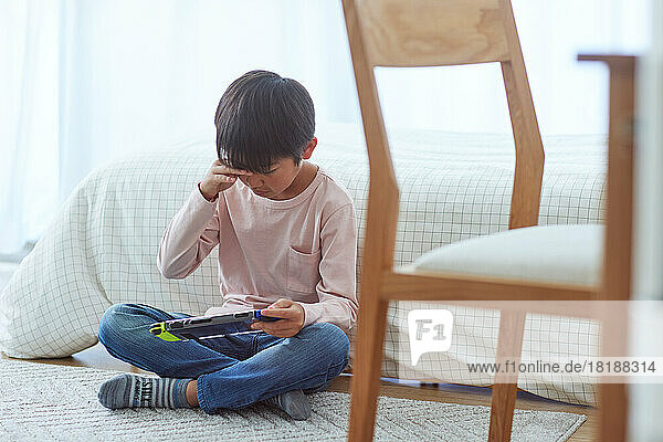 Japanese kid playing games at home