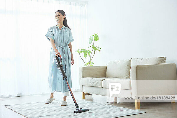 Japanese senior woman cleaning at home