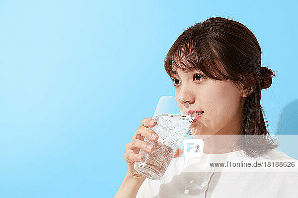 Young Japanese woman drinking water