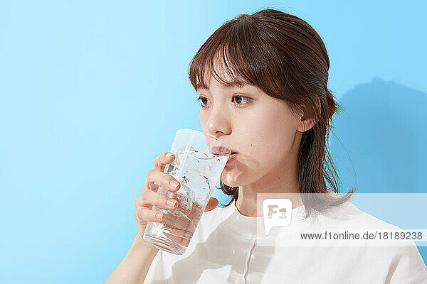 Young Japanese woman drinking water