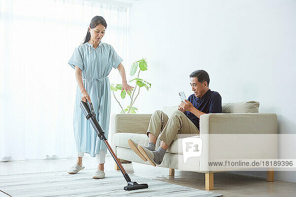 Japanese senior woman cleaning at home