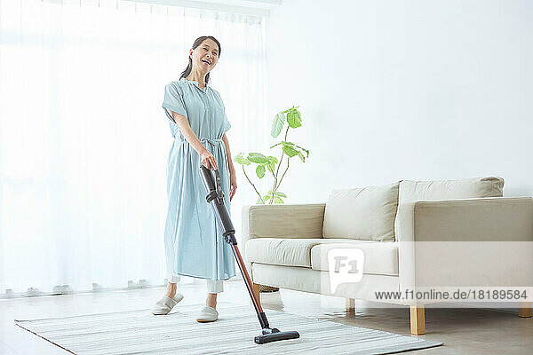 Japanese senior woman cleaning at home