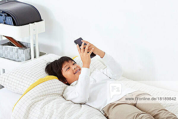 Japanese kid using smartphone at home