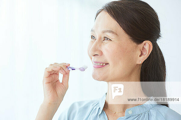 Japanese senior woman brushing teeth