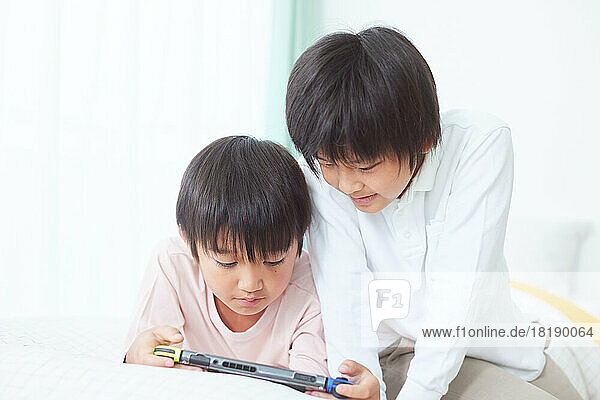 Japanese kids playing games at home