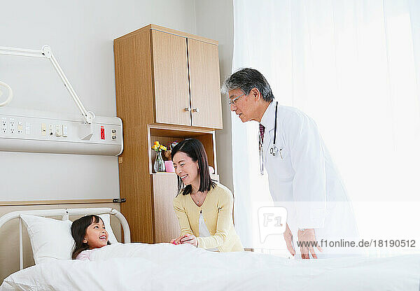 Japanese girl being examined by a doctor in a hospital room