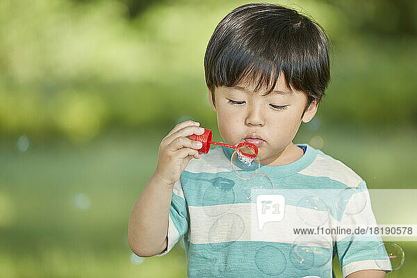 Japanese boy blowing bubbles