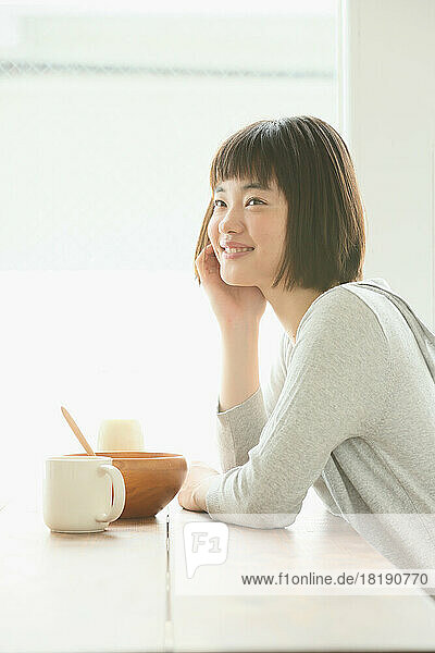Young Japanese woman having her breakfast
