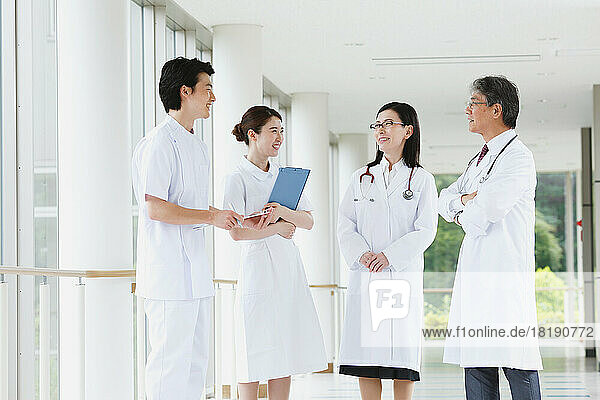 Smiling medical team having a conversation in the hallway