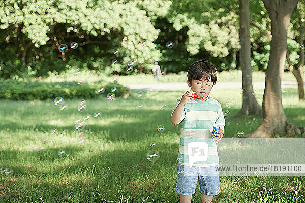 Japanese boy playing with bubbles