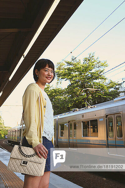 Young Japanese woman waiting for the train