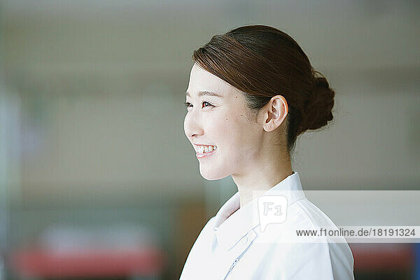Smiling young Japanese female nurse