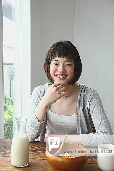 Young Japanese woman having breakfast