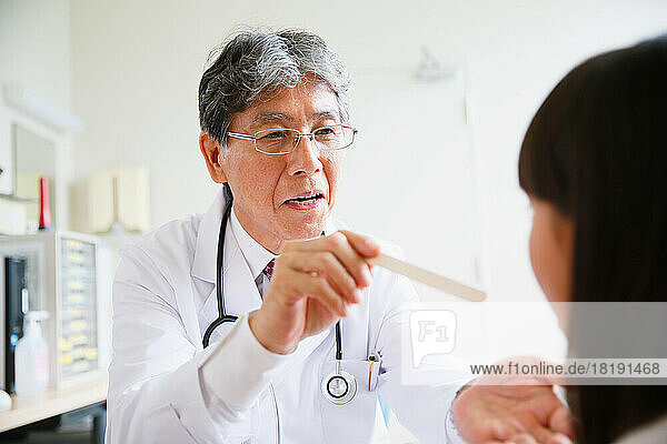 Japanese doctor examining patient