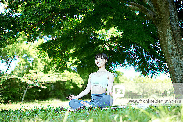Young Japanese woman training at a city park
