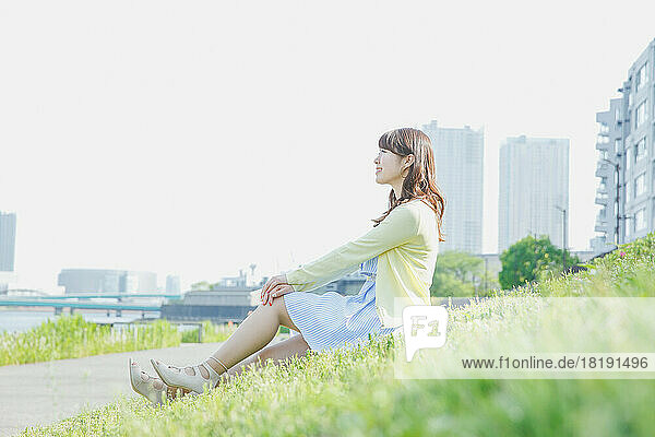 Japanese woman relaxing on the grass