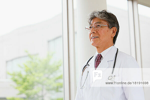 Smiling Japanese doctor in the hallway