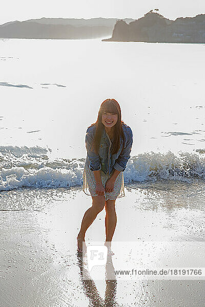 Young Japanese woman frolic on the beach