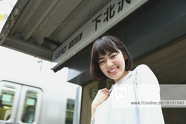 Young Japanese woman exiting the train station