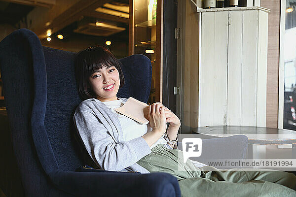 Young Japanese woman relaxing in a cafe