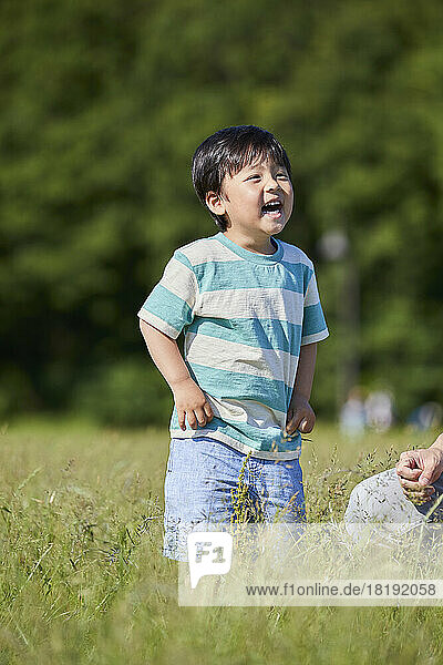 Smiling Japanese boy in the field