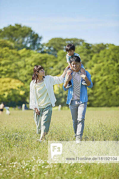 Japanese family walking in the park