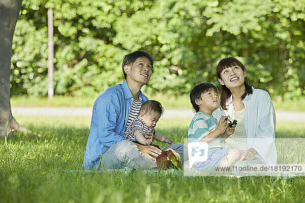 Japanese family relaxing on the lawn