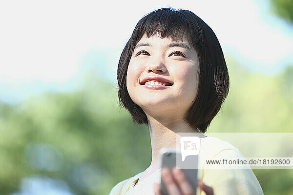 Young Japanese woman with mobile phone