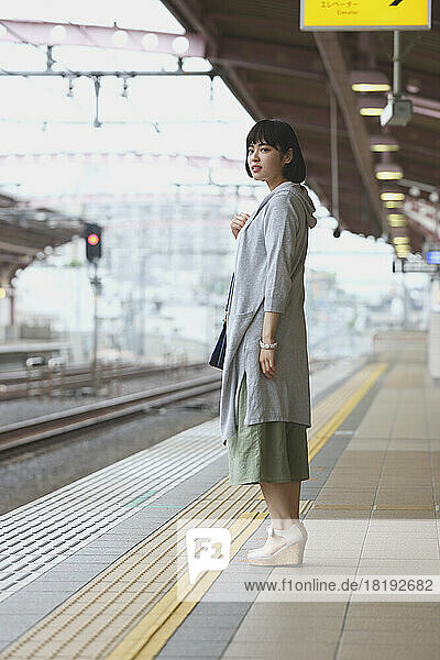 Young Japanese woman on a train platform