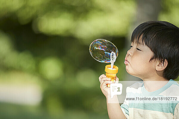 Japanese boy blowing bubbles