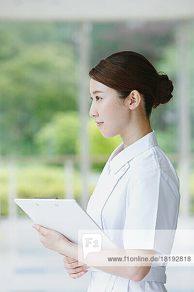 Young Japanese female nurse in the corridor
