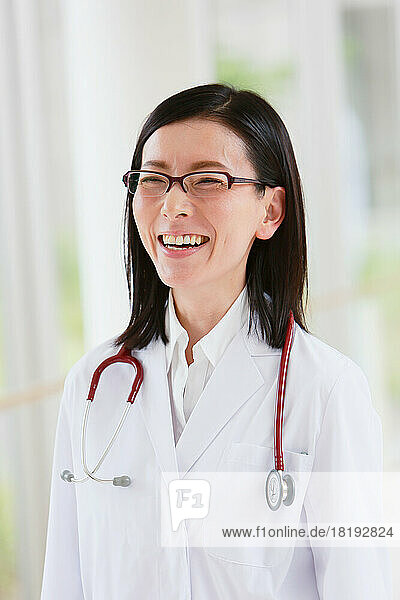 Smiling Japanese doctor in the hallway