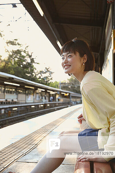 Young Japanese woman waiting for the train