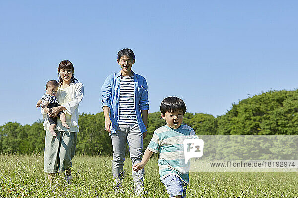 Japanese family taking a walk in the field