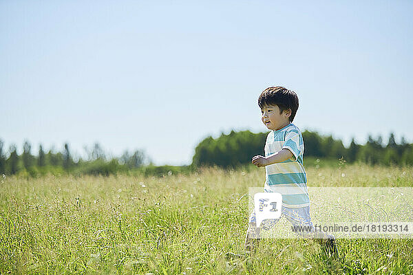 Japanese boy running in the field