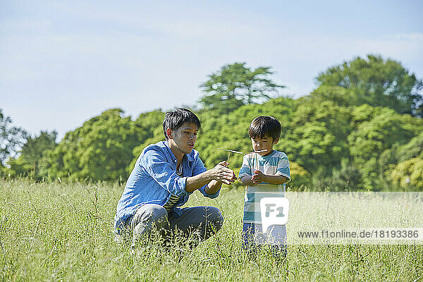 Japanese parent and child playing with bamboo copter
