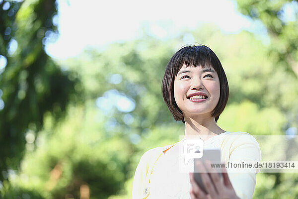 Young Japanese woman with mobile phone
