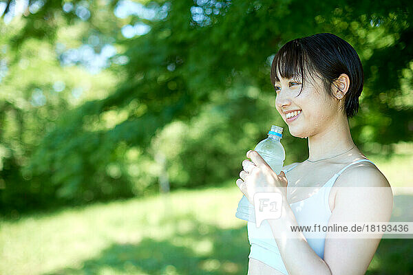 Young Japanese woman training at a city park