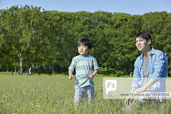 Japanese parent and child playing in the park
