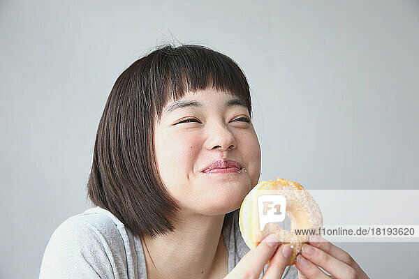Young Japanese woman eating a donut