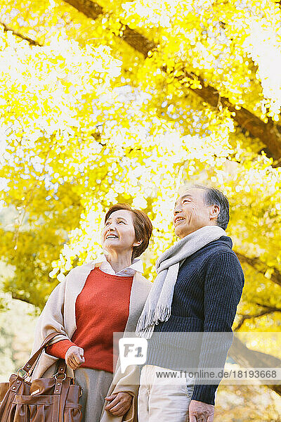 Senior couple traveling during the autumn leaves season