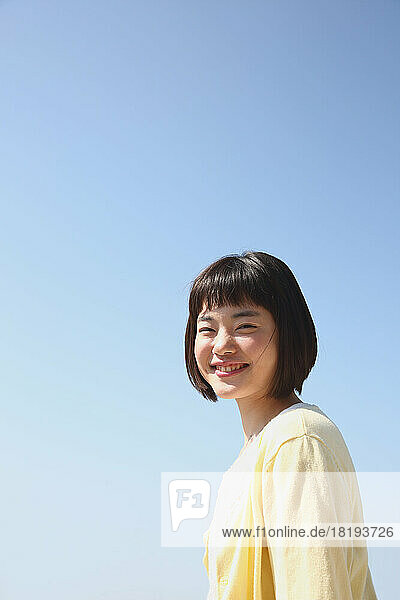 Young Japanese woman under the blue sky