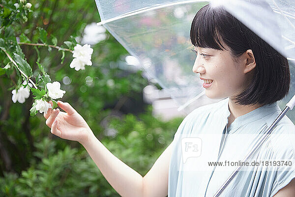 Japanese woman with umbrella under the rain