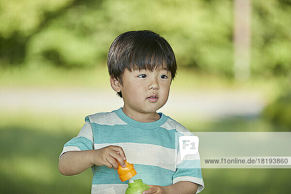 Japanese boy playing with bubbles