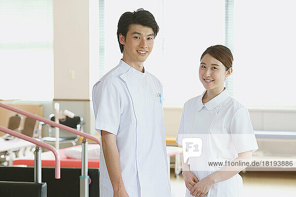 Smiling young Japanese nurses in rehab facility
