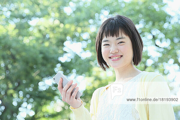 Young Japanese woman holding a mobile phone