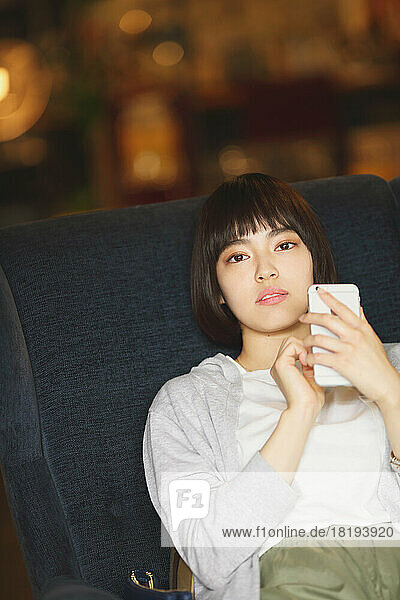Young Japanese woman relaxing at a cafe