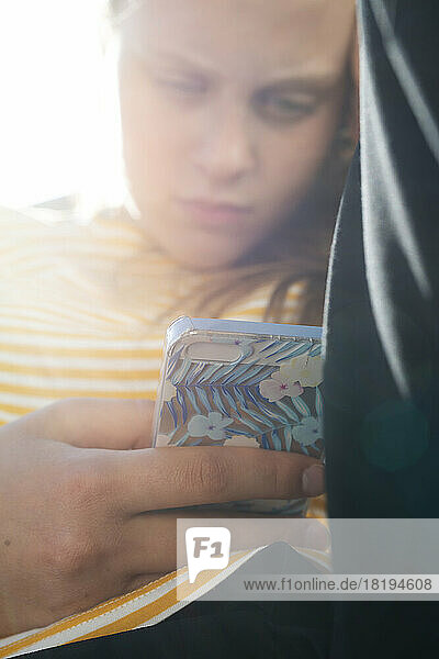 Teenage girl text messaging on smartphone